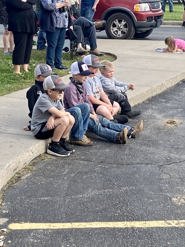 A group of 5 elementary students watching the Prom Walk-In