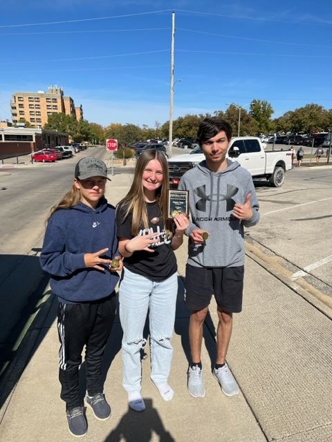 Students hold medals from meet